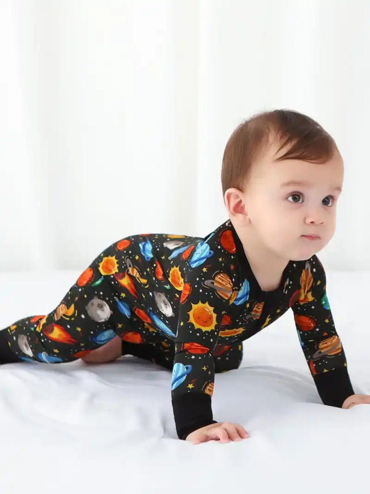Bulk baby boy zipper rompers with printed designs.
